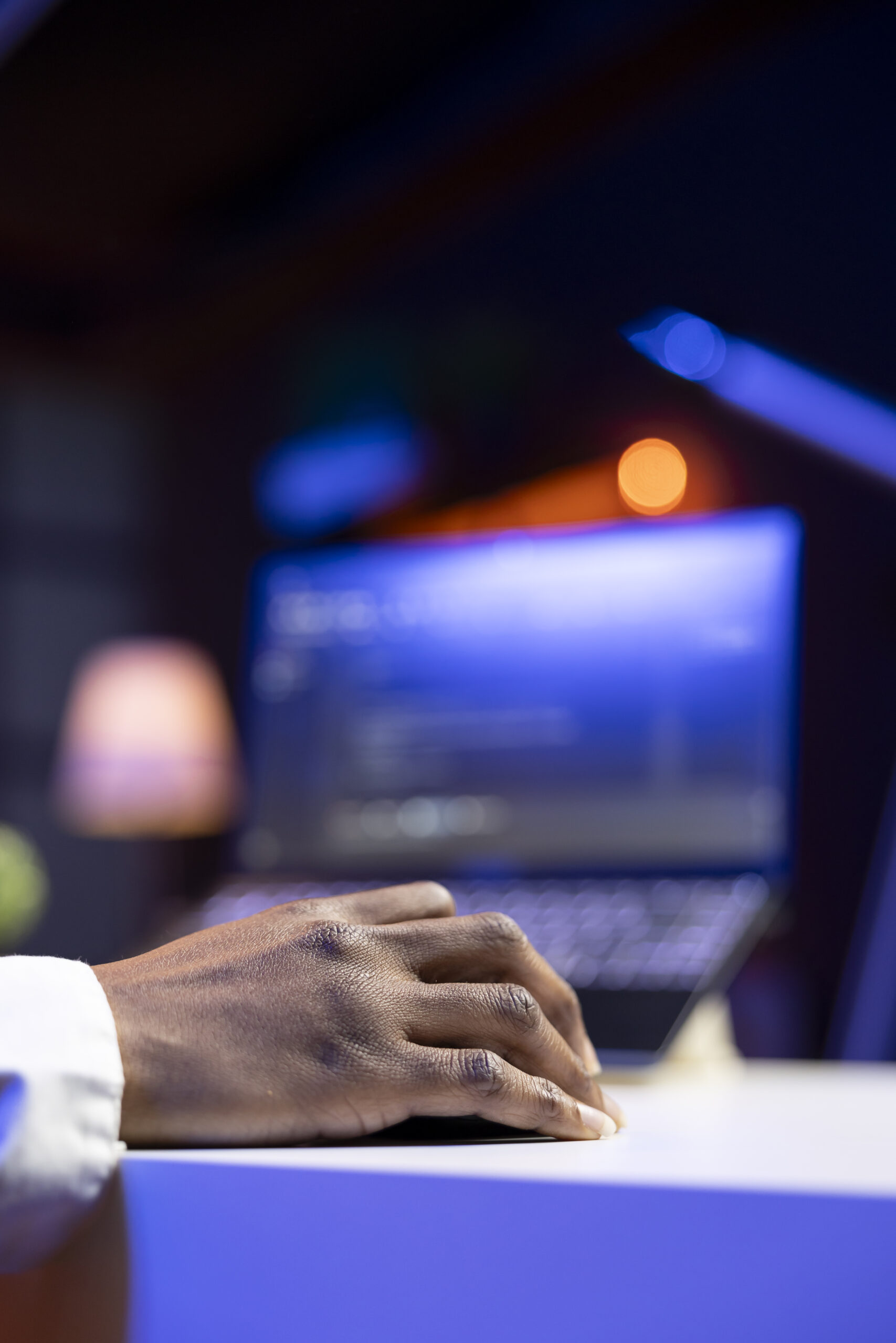teleworker in living room office using laptop to do coding, close up
